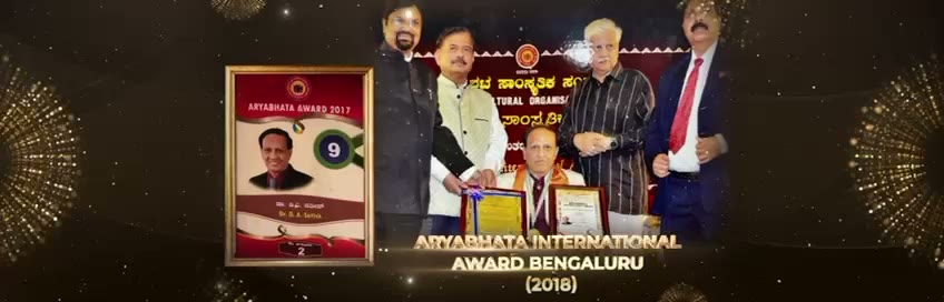 Framed Aryabhata Award plaque with a headshot, alongside a stage photo of the award handover with four people.